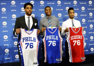 Philadelphia 76ers NBA draft picks Jahlil Okafor, left, Richaun Holmes, center, and J.P. Tokoto hold up jerseys during a press conference at the 76ers practice facility, Saturday, June 27, 2015, in Philadelphia. (AP Photo/Michael Perez) ORG XMIT: PAMP108