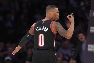 Portland Trail Blazers guard Damian Lillard gestures after scoring during the second half of an NBA basketball game against the Los Angeles Lakers, Sunday, Jan. 11, 2015, in Los Angeles.  The Heat won 106-94. (AP Photo/Mark J. Terrill)
