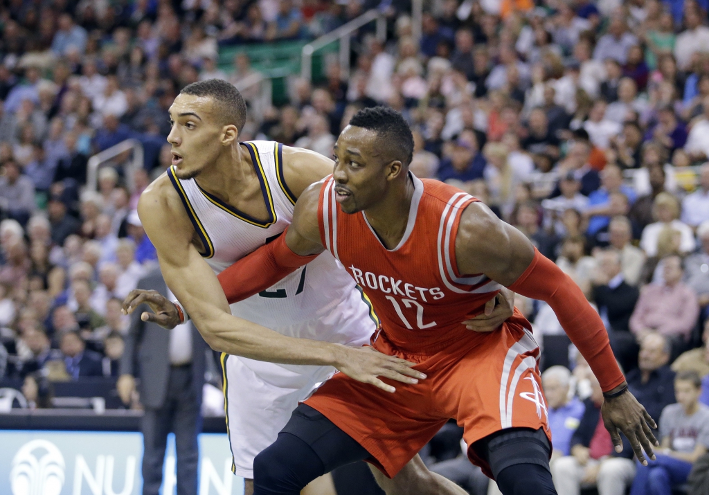 Utah Jazz's Rudy Gobert, left, guards Houston Rockets' Dwight Howard (12) in the first half during an NBA basketball game Wednesday, Oct. 29, 2014, in Salt Lake City. (AP Photo/Rick Bowmer)