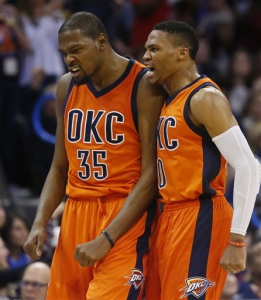Oklahoma City Thunder forward Kevin Durant (35) and guard Russell Westbrook, right, shout after a 3-point basket by Durant in the third quarter of an NBA basketball game against the Utah Jazz in Oklahoma City, Sunday, Dec. 13, 2015. (AP Photo/Sue Ogrocki)