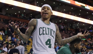 Boston Celtics guard Isaiah Thomas (4) gestures from the bench to a fan in the fourth quarter of an NBA basketball game against the Milwaukee Bucks, Thursday, Feb. 25, 2016, in Boston. (AP Photo/Elise Amendola)