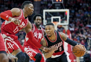 Feb 6, 2016; Houston, TX, USA; Portland Trail Blazers guard Damian Lillard (0) dribbles against Houston Rockets center Dwight Howard (12) in the second half at Toyota Center. Portland won 96 to 79. Mandatory Credit: Thomas B. Shea-USA TODAY Sports
