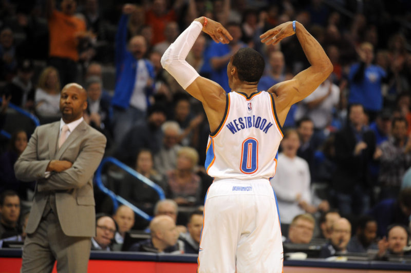 Feb 22, 2015; Oklahoma City, OK, USA; Oklahoma City Thunder guard Russell Westbrook (0) reacts after a play against the Denver Nuggets at Denver Nuggets head coach Brian Shaw looks on during the second quarter at Chesapeake Energy Arena. Mandatory Credit: Mark D. Smith-USA TODAY Sports